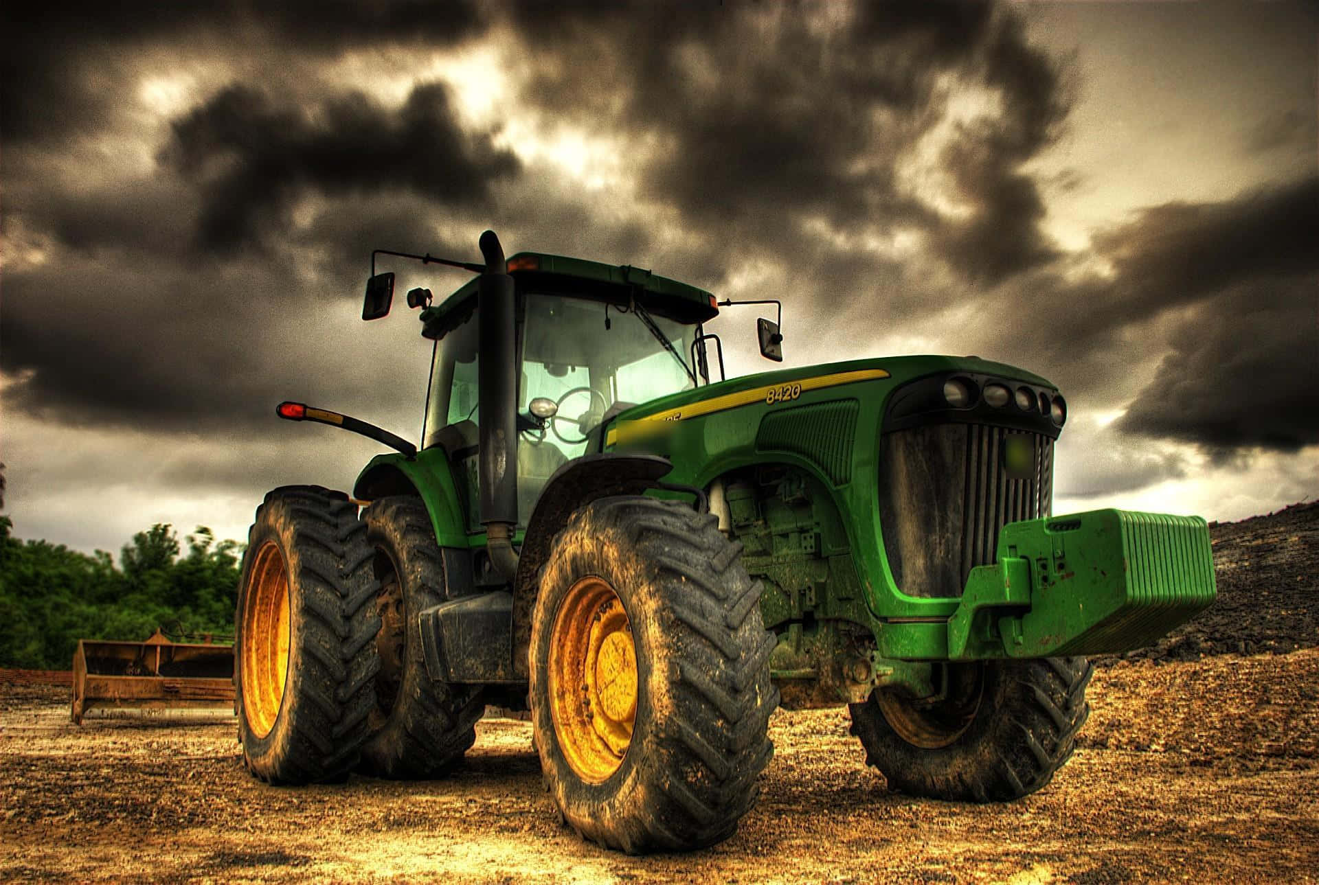 Green Tractor Under Gloomy Sky Picture