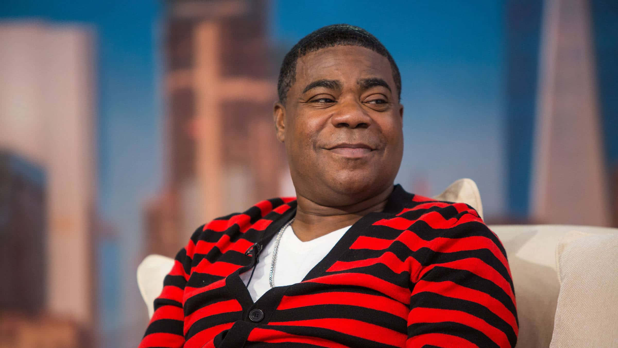 Tracy Morgan - Smiling on stage in front of camera Wallpaper