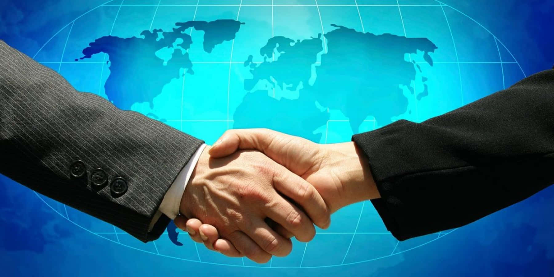 Two Business People Shaking Hands In Front Of A World Map