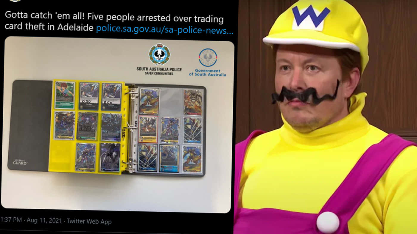 A Man In A Mario Costume Is Holding A Card