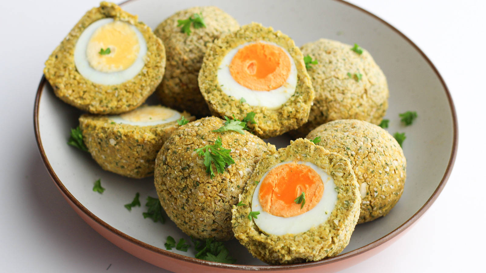 Mouth-Watering Traditional British Scotch Eggs Garnished with Herbs Wallpaper