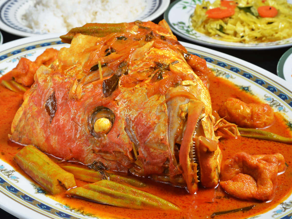 Piattatradizionale Malese Di Curry Di Testa Di Pesce Sfondo