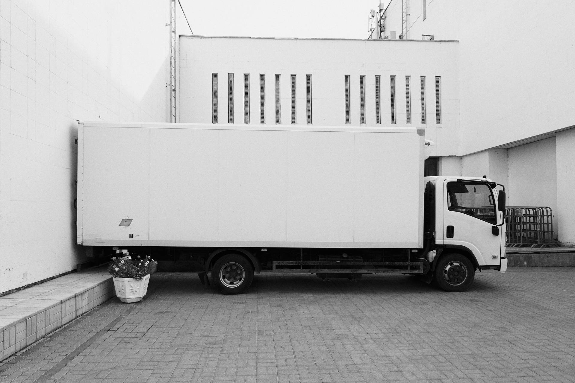 Majestic trailer truck parked at a commercial building Wallpaper