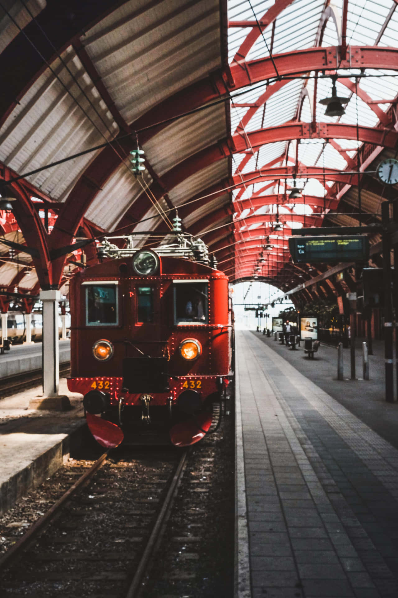 A Red Train Is Parked At A Train Station