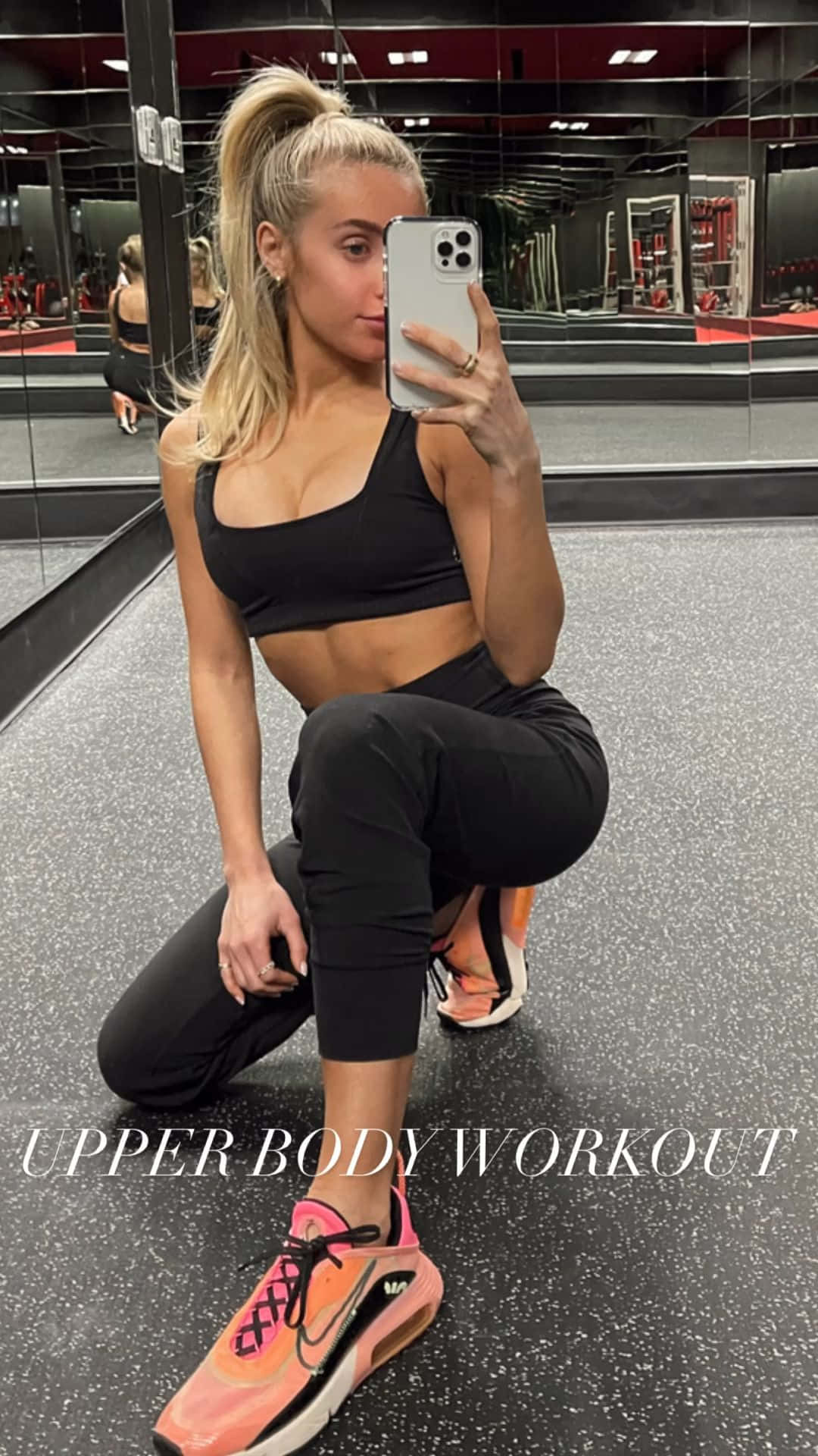a woman taking a selfie in a gym Wallpaper