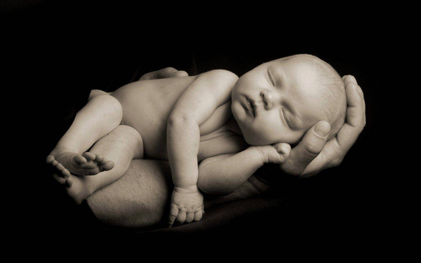 Tranquil Newborn In Calm Sleep Wallpaper