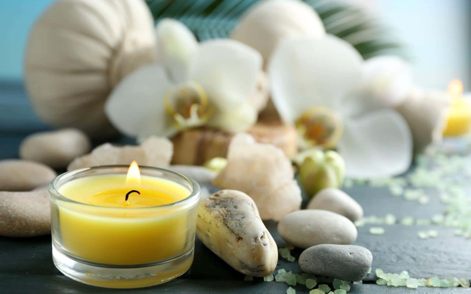Tranquil Spa Settingwith Candleand Orchids Wallpaper