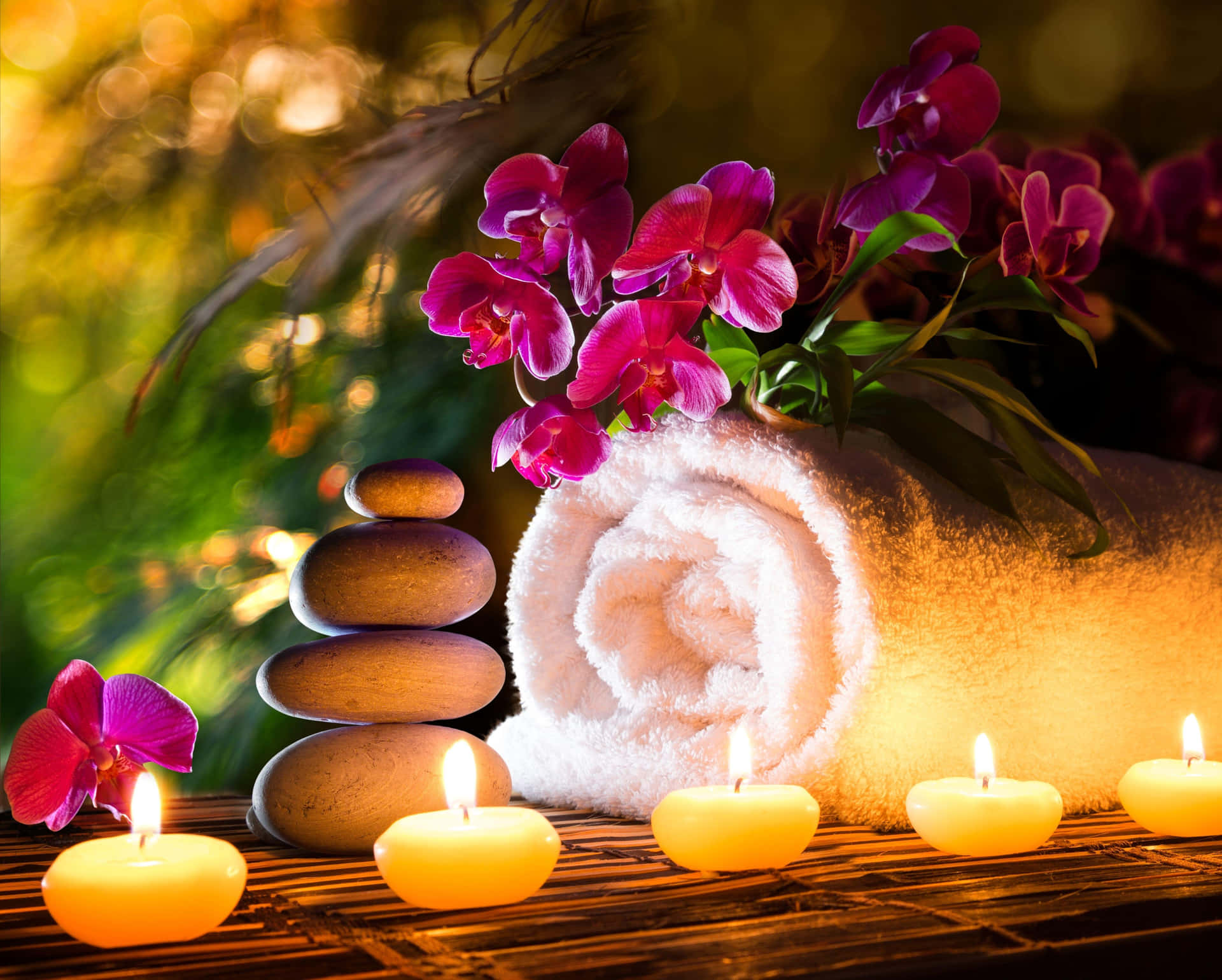 Tranquil Spa Settingwith Candlesand Orchids Wallpaper