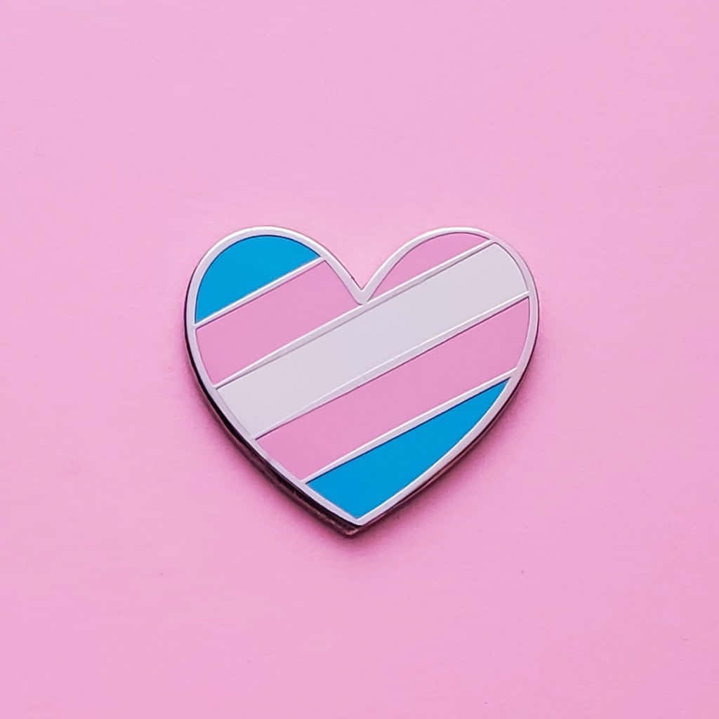 A Heart Shaped Pin With A Rainbow And Blue Stripe Wallpaper