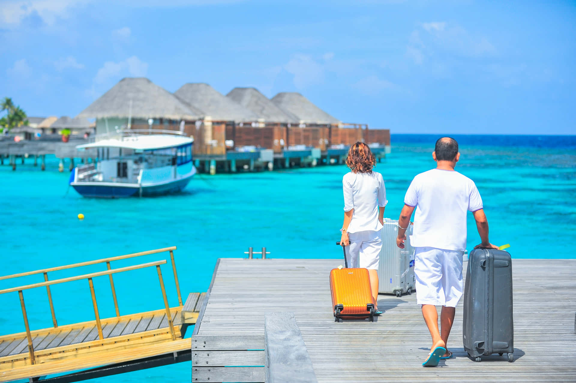 Two People Walking Down A Pier With Luggage Wallpaper