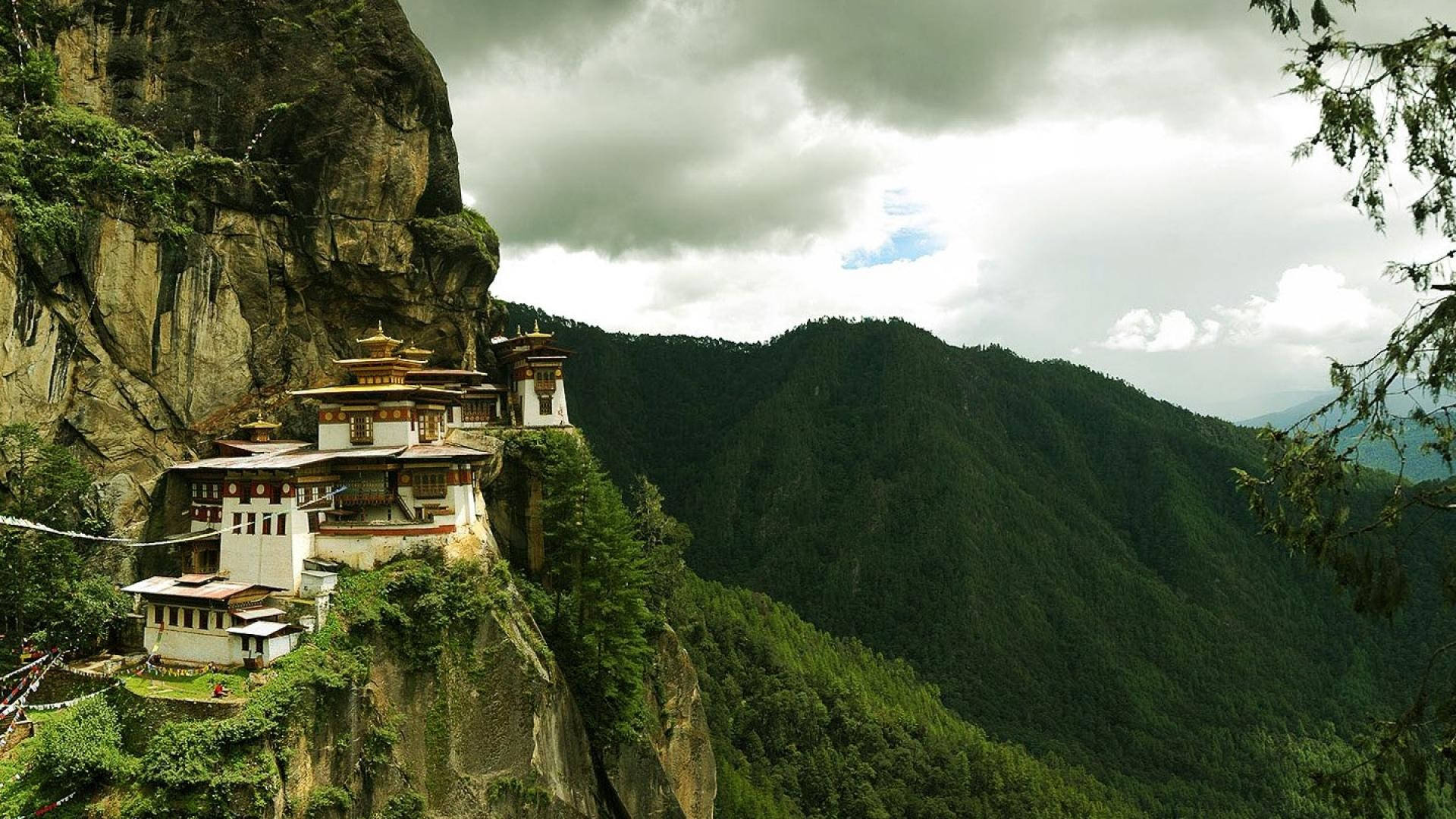 A Monastery Is Perched On A Cliff Wallpaper