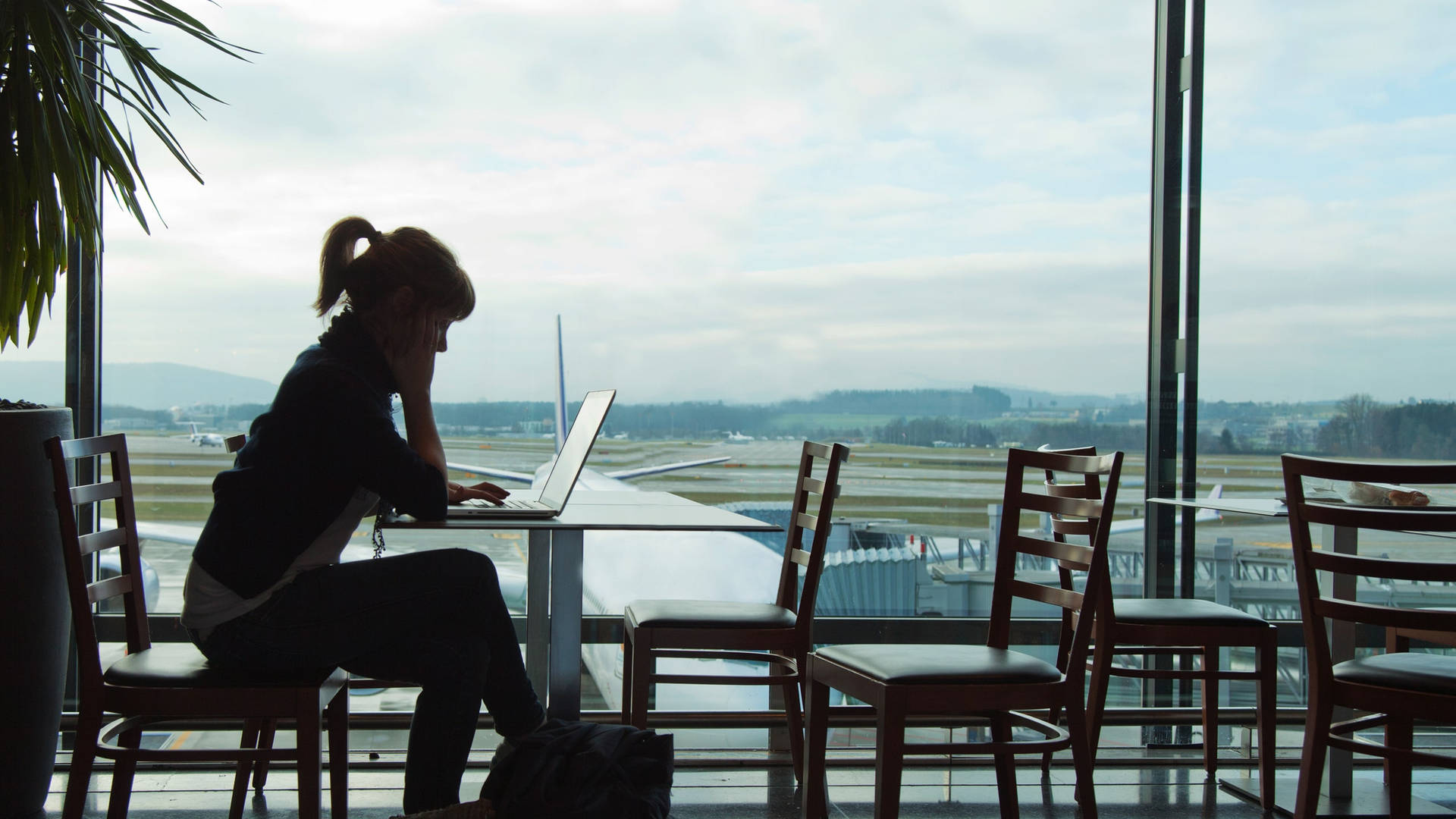 Girl Using A Travel Laptop Side View Shot Wallpaper