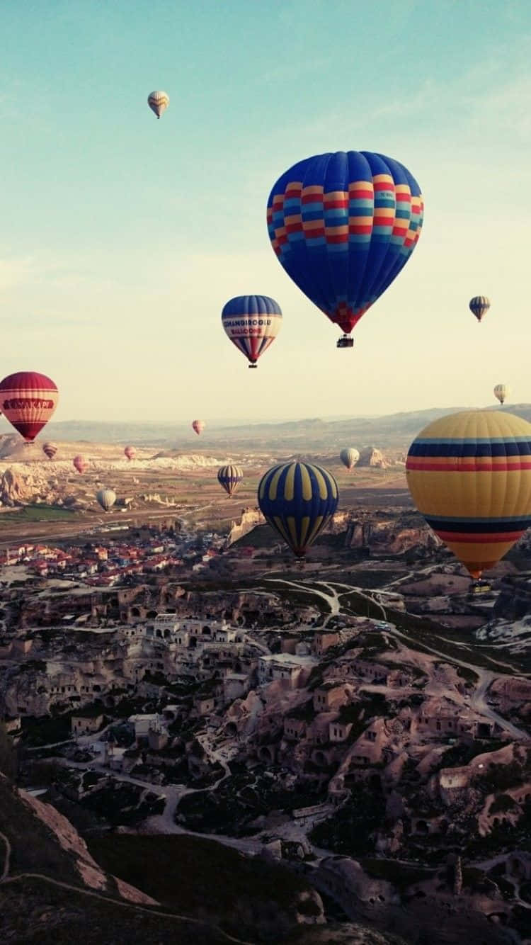 Hot Air Balloons Flying Over A City Wallpaper