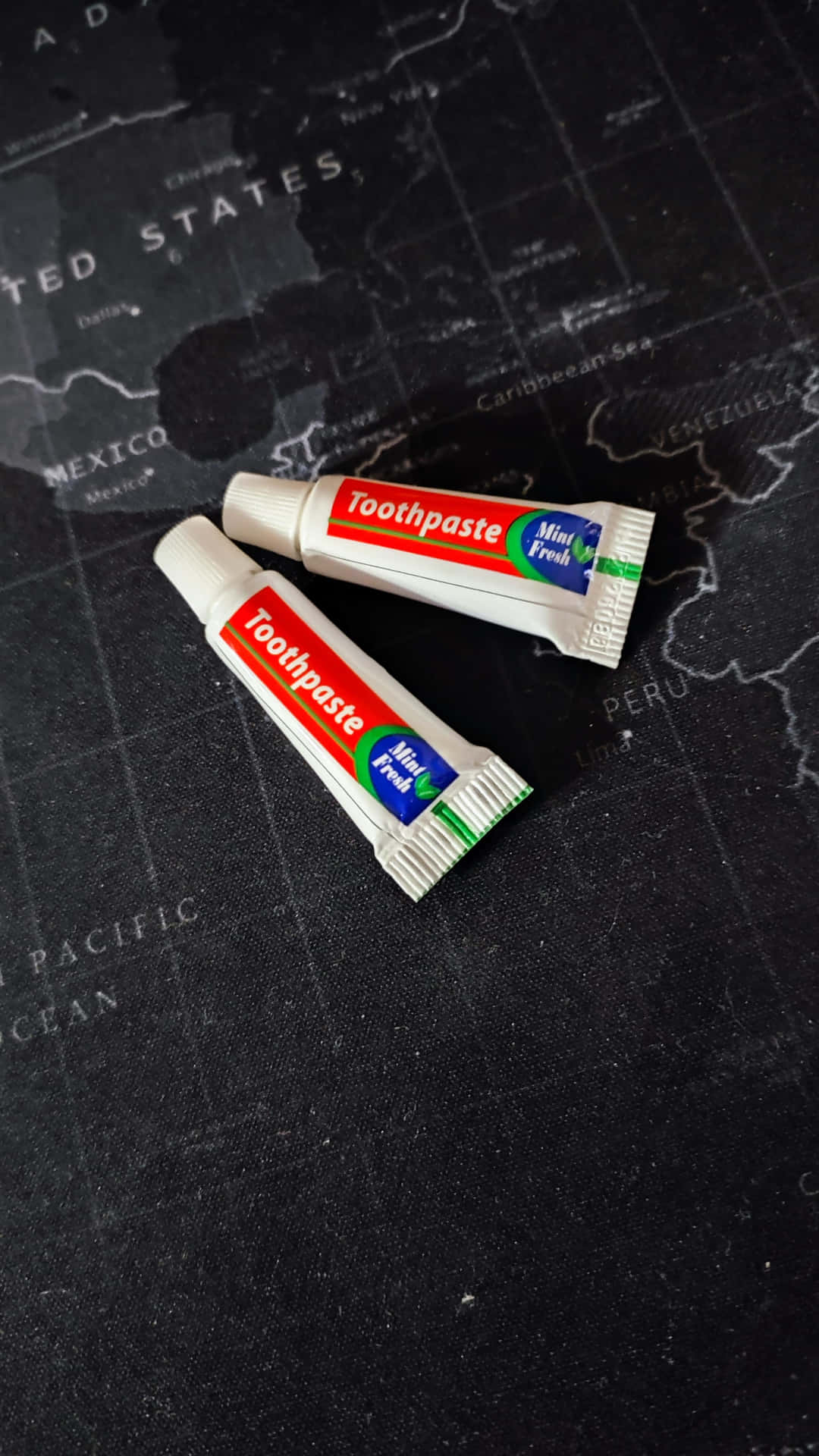 Download Travel Size Toothpasteon Map Wallpaper | Wallpapers.com