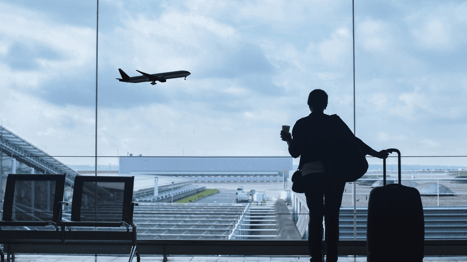 Traveler Watching Airplane Takeoff