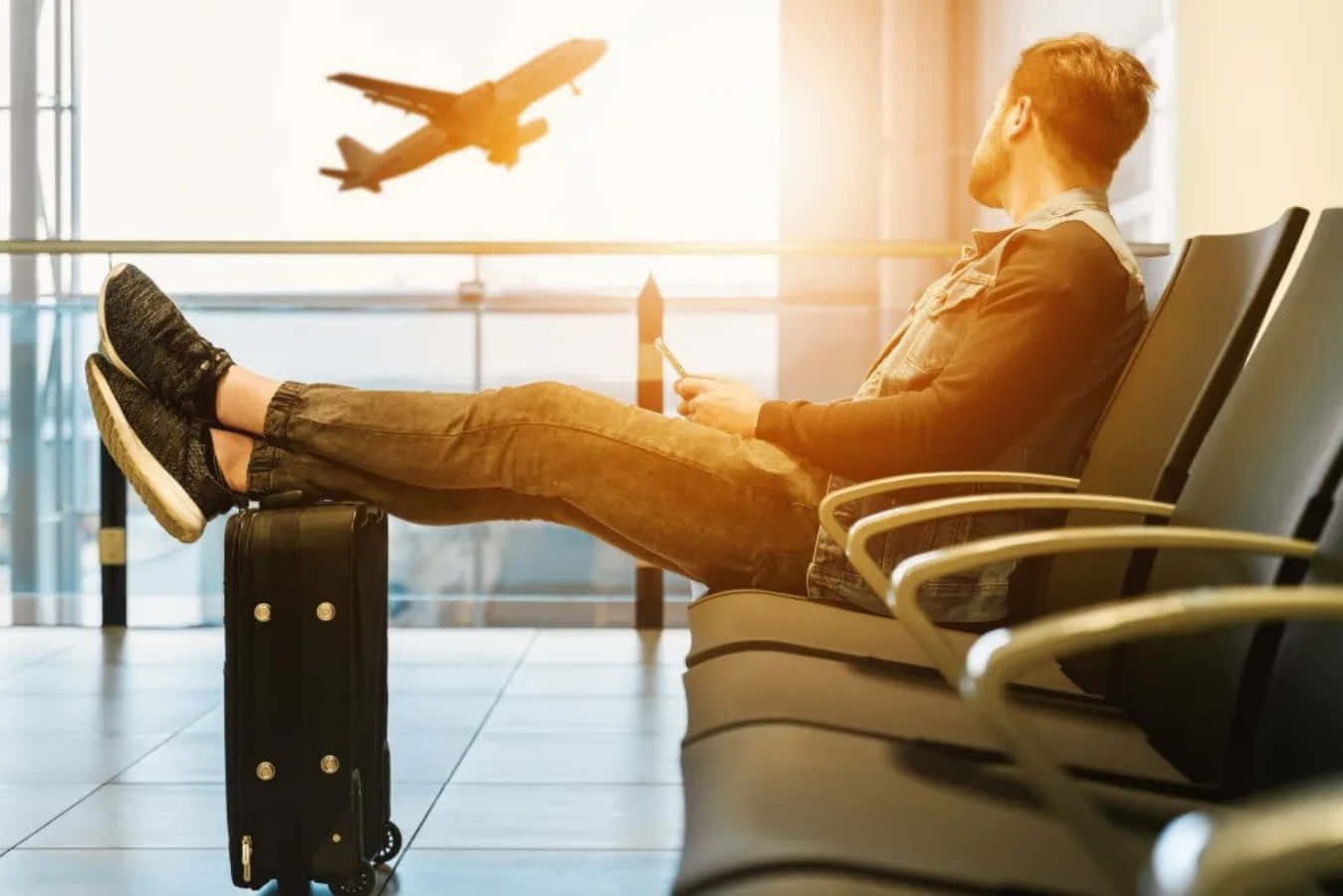 Man Sitting In Airport Waiting For Plane