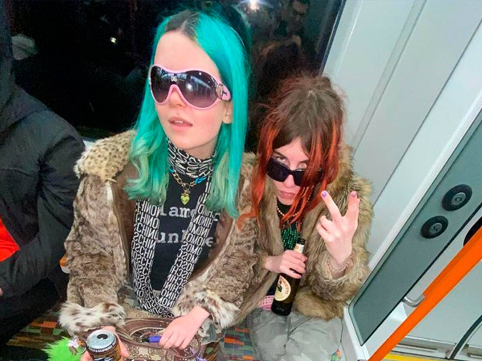 Two Women With Green Hair On A Bus Wallpaper