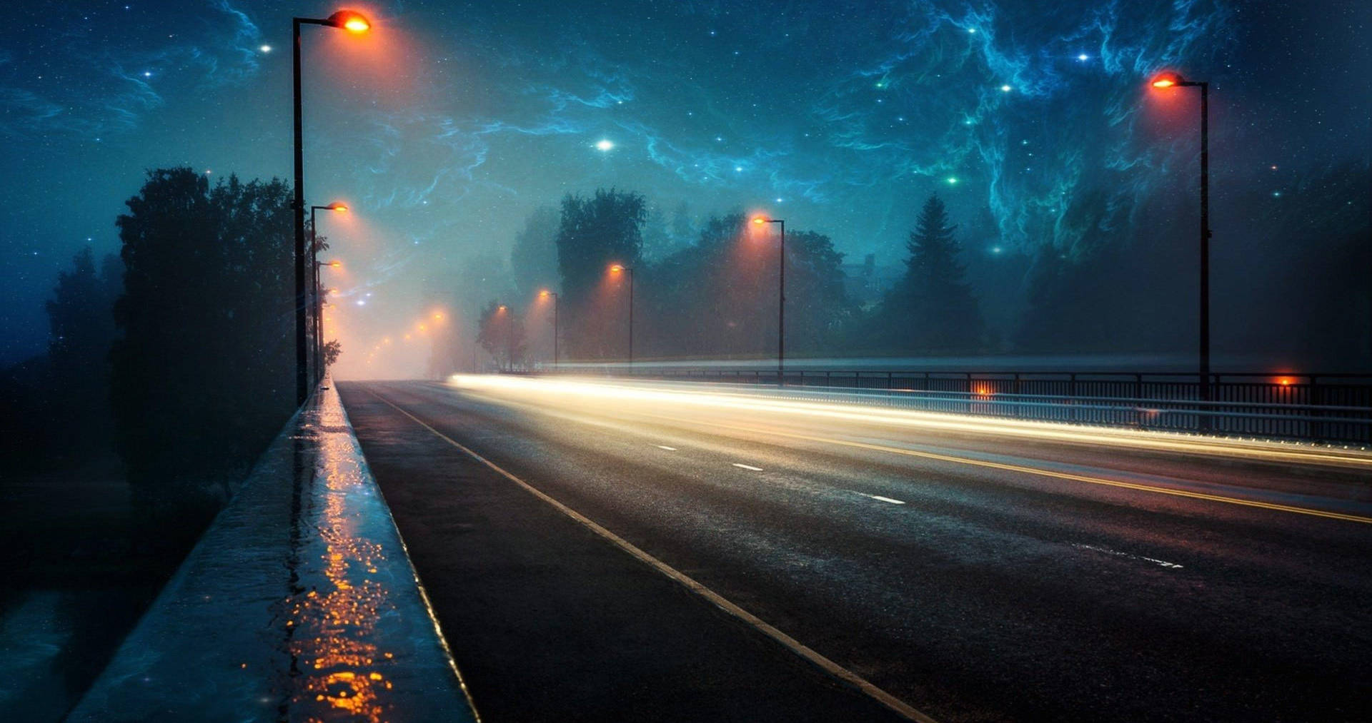 A Road With Lights And Stars In The Sky Wallpaper