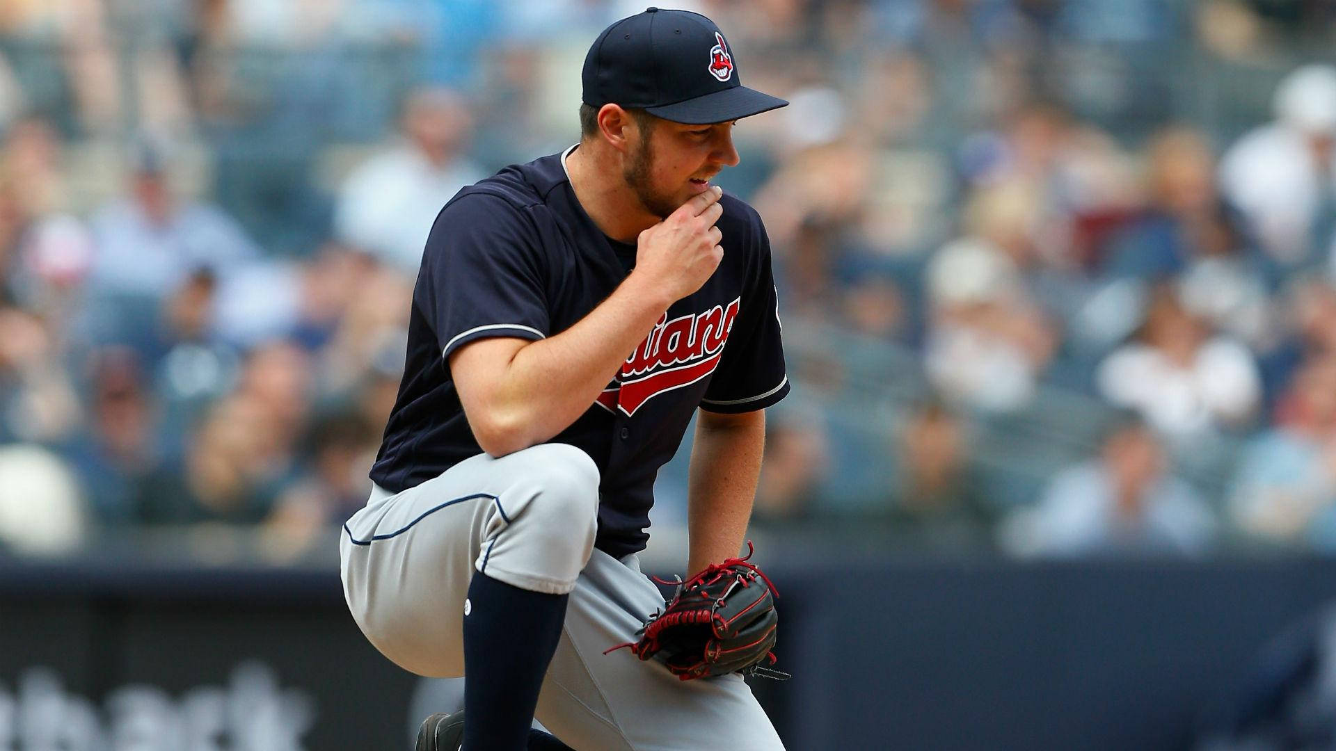 Download Trevor Bauer Crouching During A Game Wallpaper
