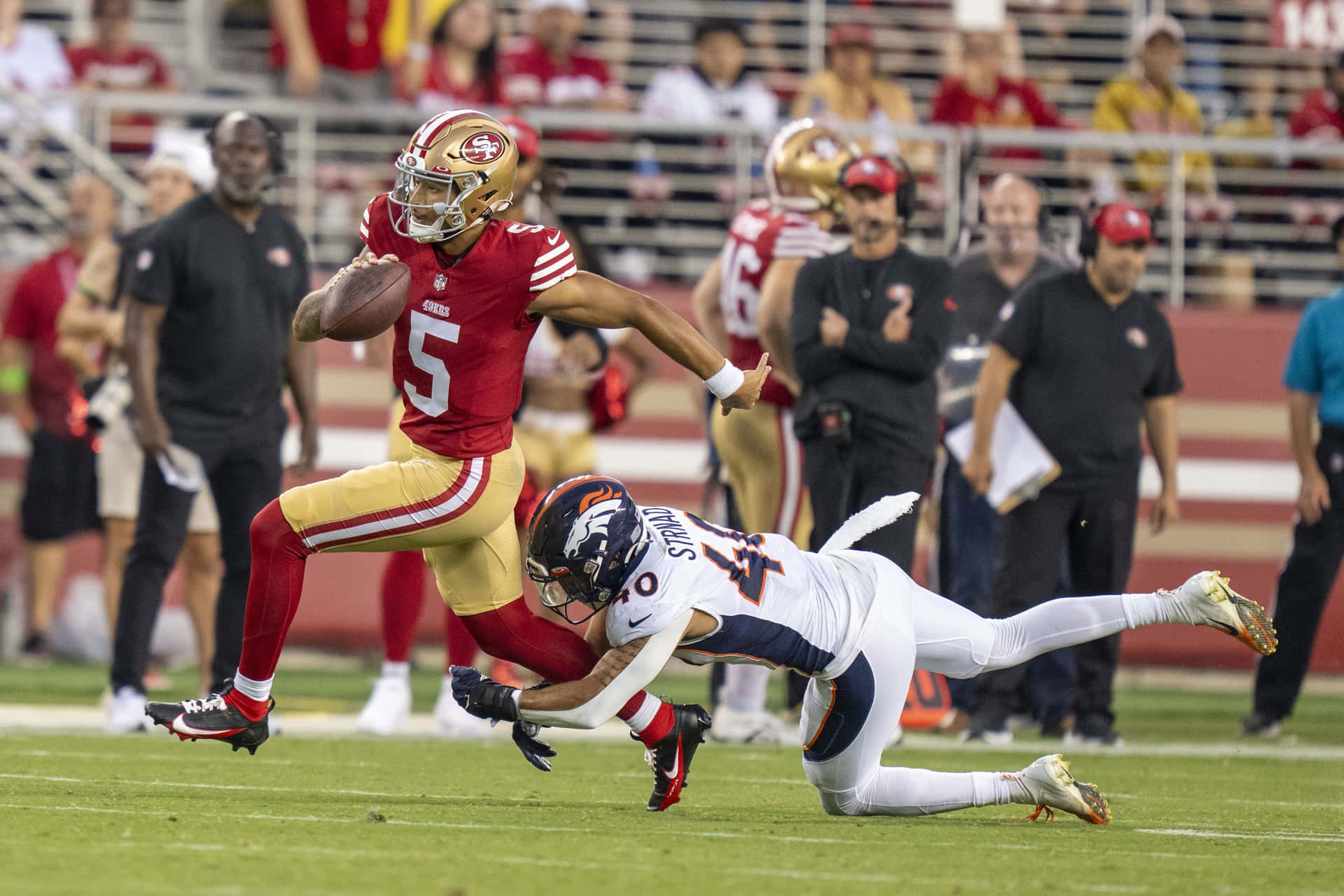 Trey Lance Evading Tackle During Game Wallpaper