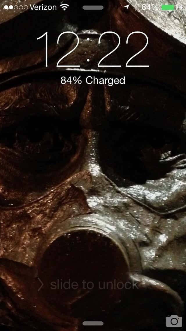 A Phone Screen Showing A Mask With A Skull Wallpaper