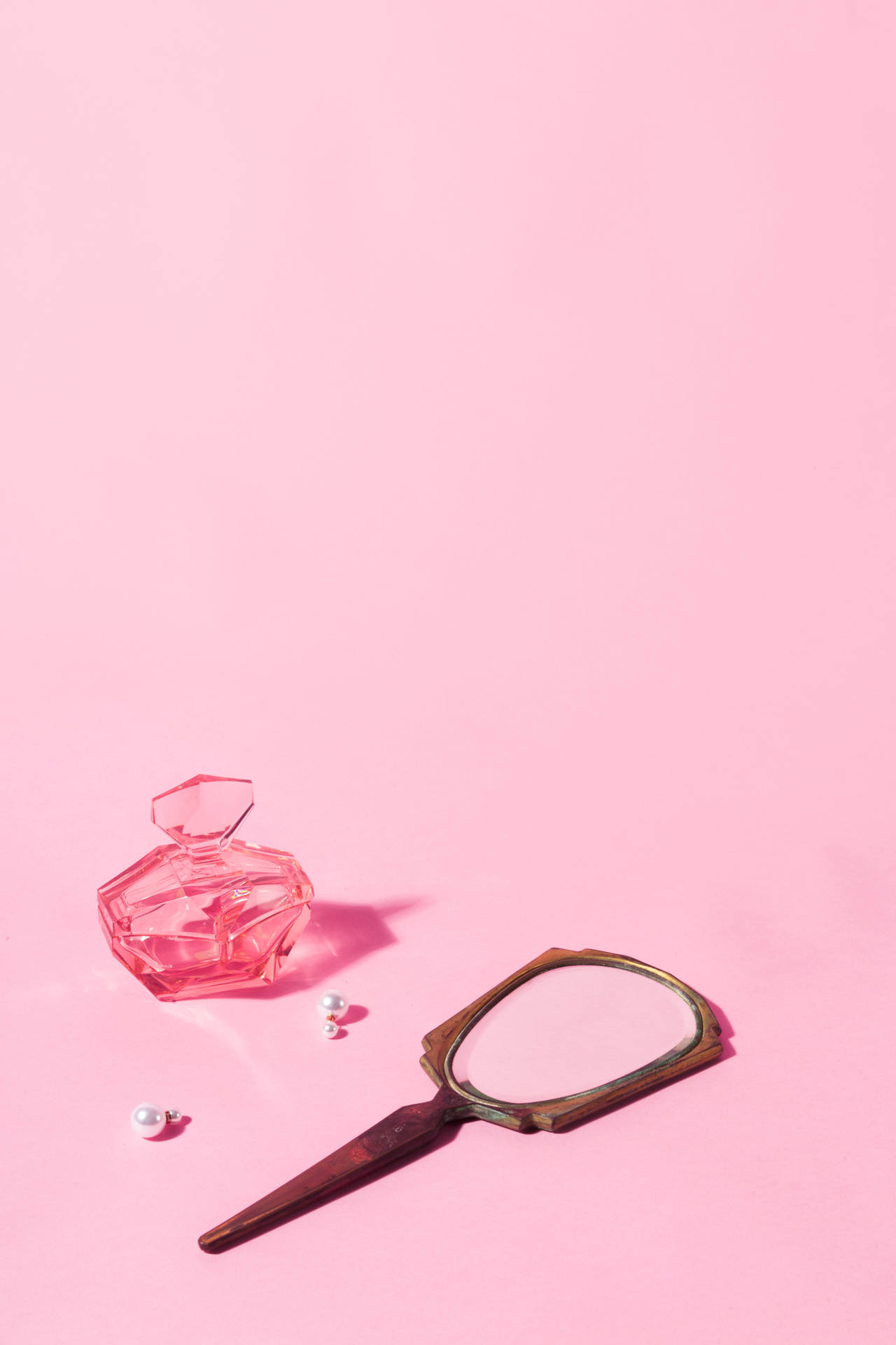 Trinkets On Pastel Pink Color Table Wallpaper