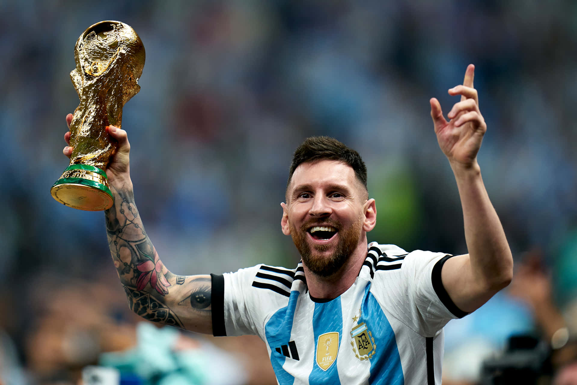 Triumphant Messi Celebration On The Football Field Wallpaper