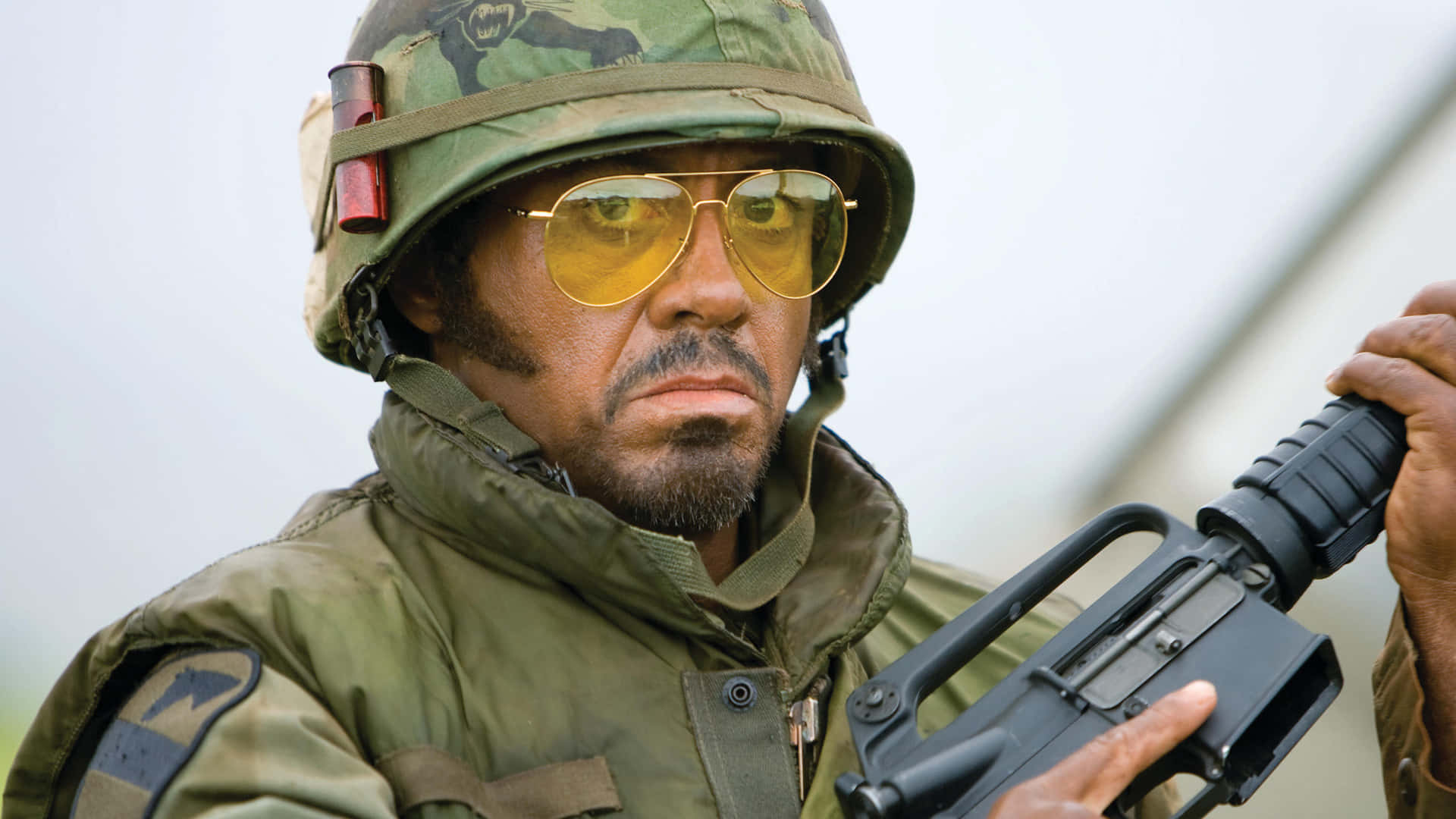 Tropic Thunder Personage Met Geweer Achtergrond