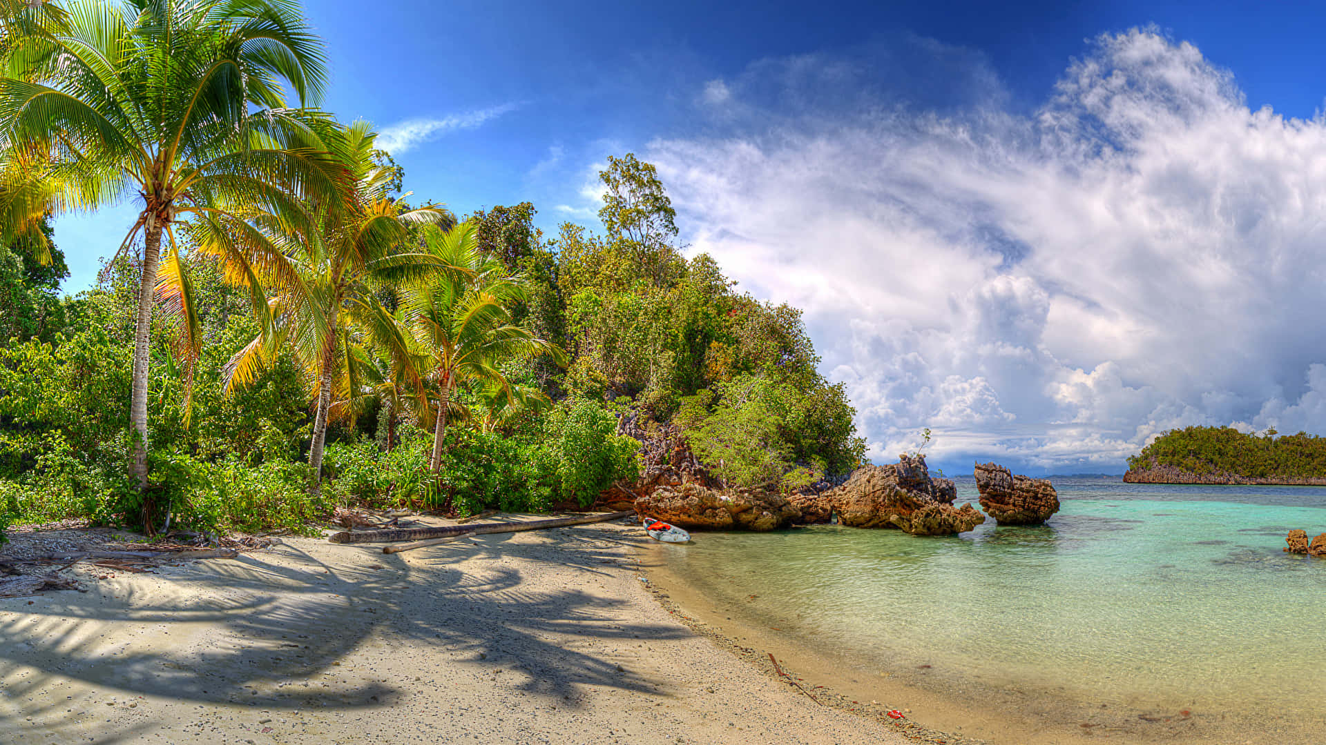 A Sandy Beach With Palm Trees Wallpaper