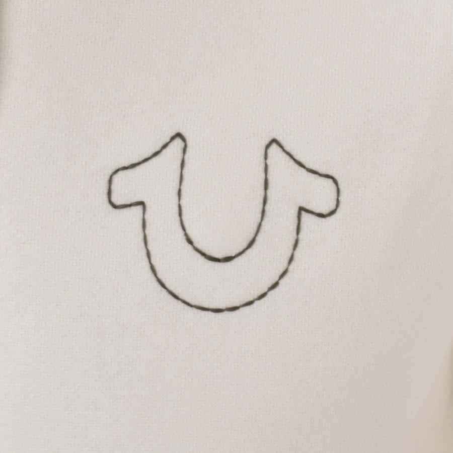 A Close Up Of A White Shirt With A U Embroidered On It Wallpaper