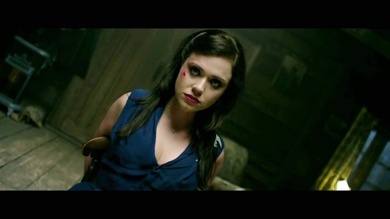 A Woman In A Blue Dress With Blood On Her Face