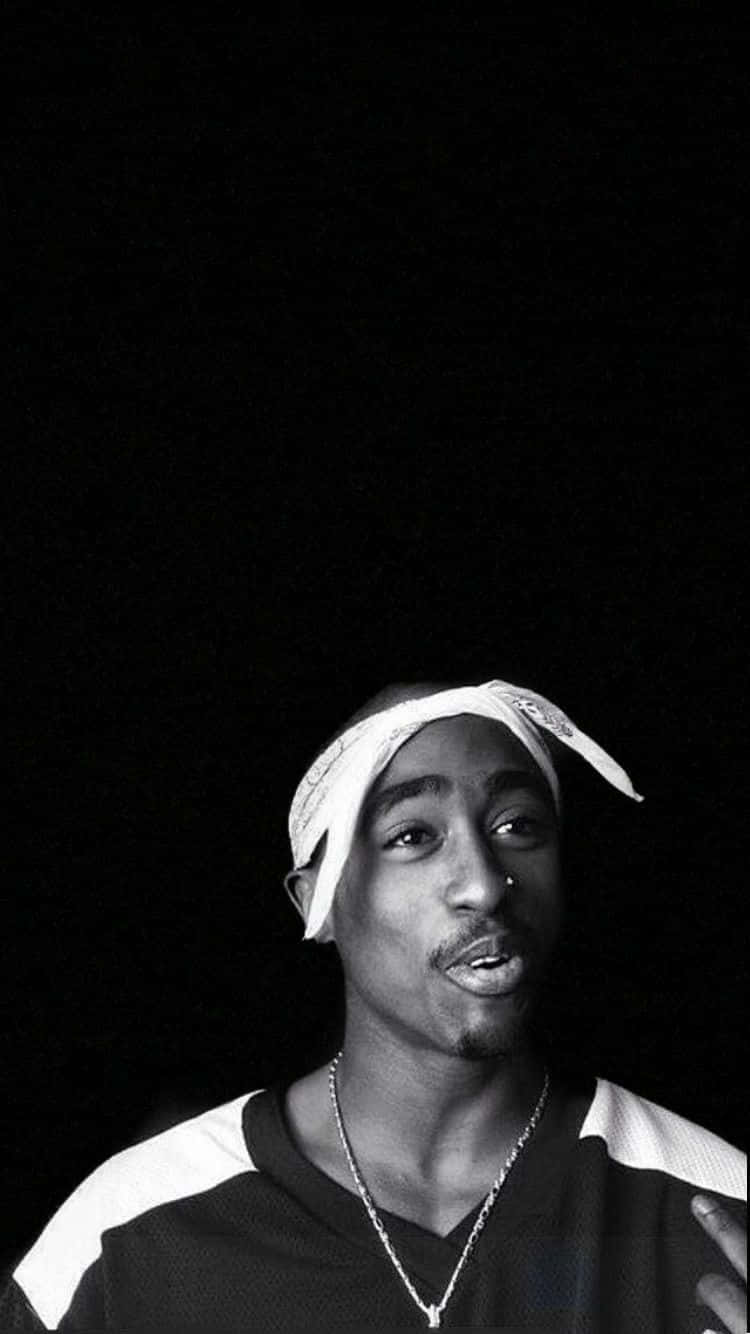 A Man With A Headband Is Standing In Front Of A Black Background Wallpaper