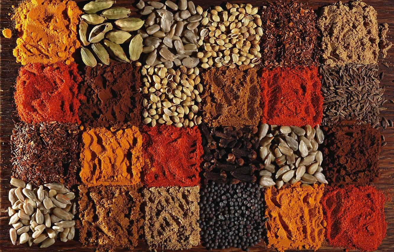 Aesthetically Displayed Collection of Indian Spices with a Focus on Turmeric Wallpaper