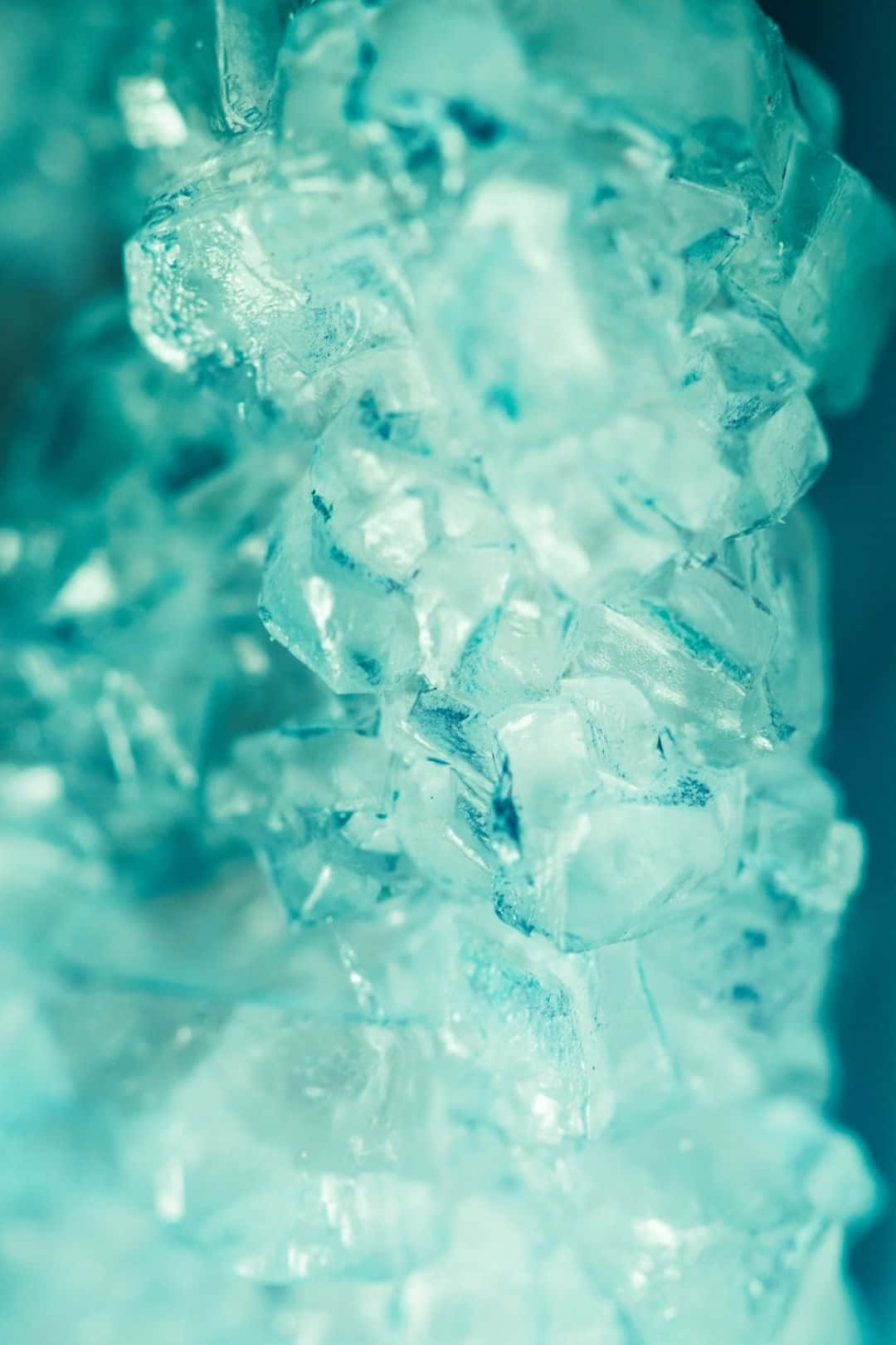 A Close Up Of Ice Cubes In A Blue Color Wallpaper