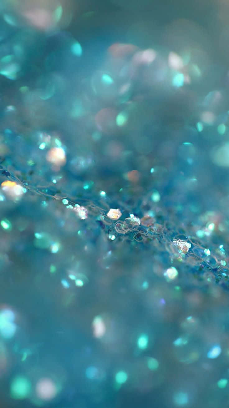 A Close Up Of A Blue Water With Glitter Wallpaper