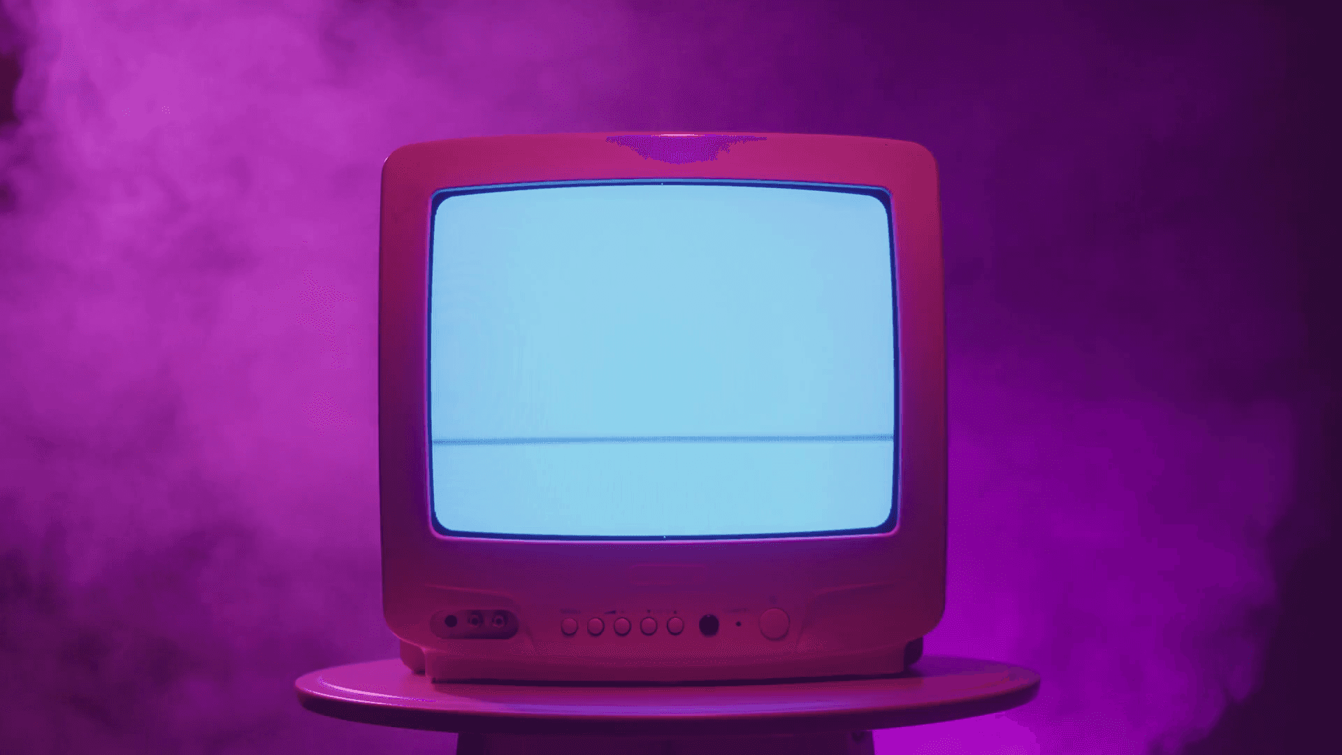 A Computer With A Purple Screen On Top Of A Table