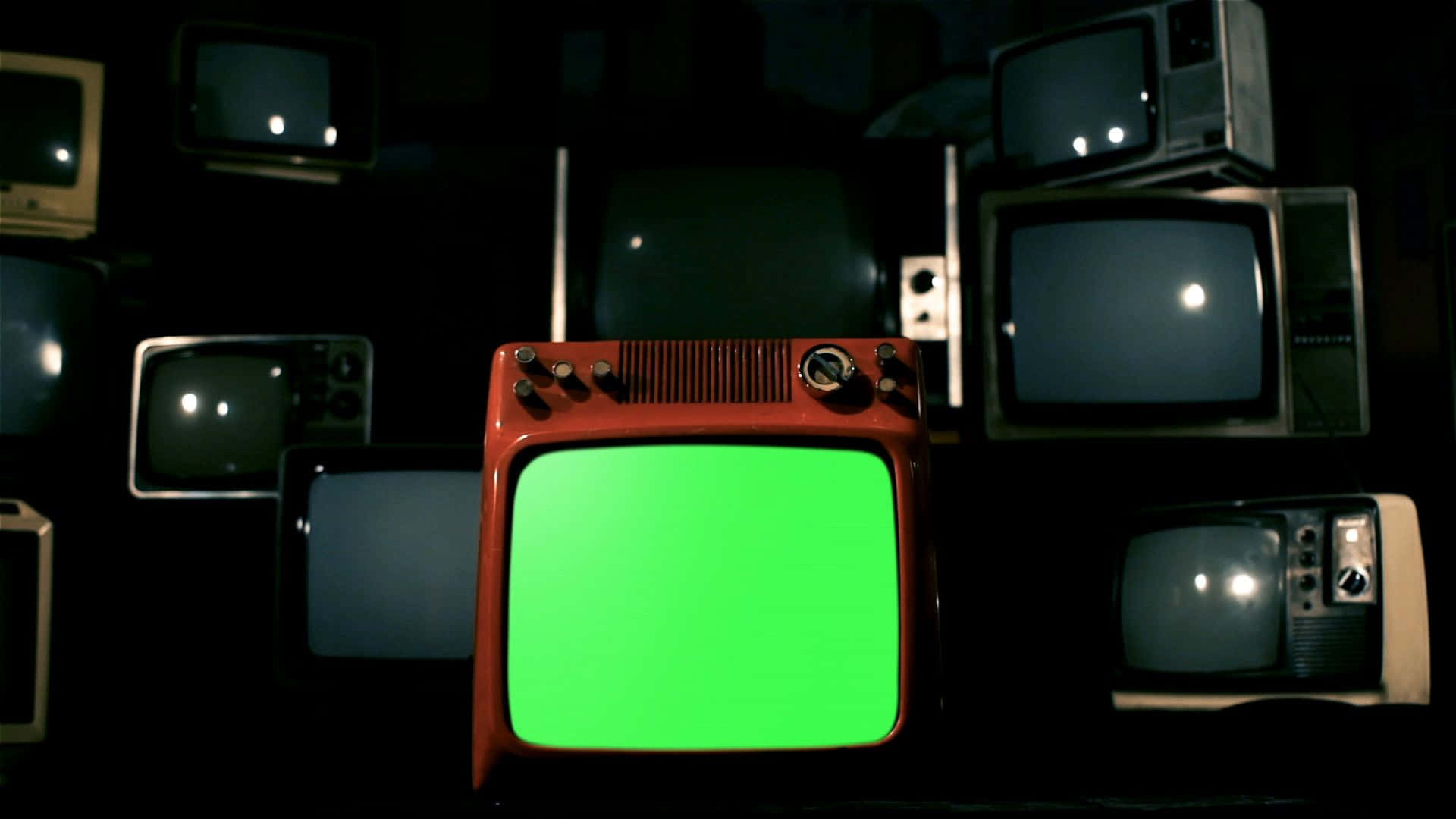Einegruppe Von Fernsehern Mit Grünen Bildschirmen.