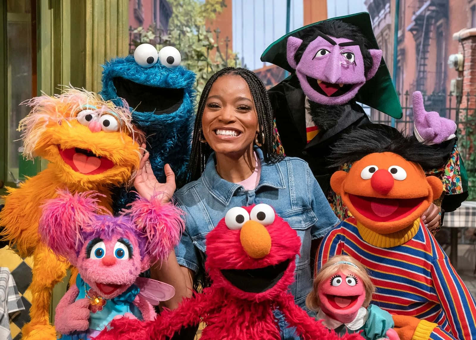 Umamulher Posa Com Um Grupo De Personagens Do Sesame Street.