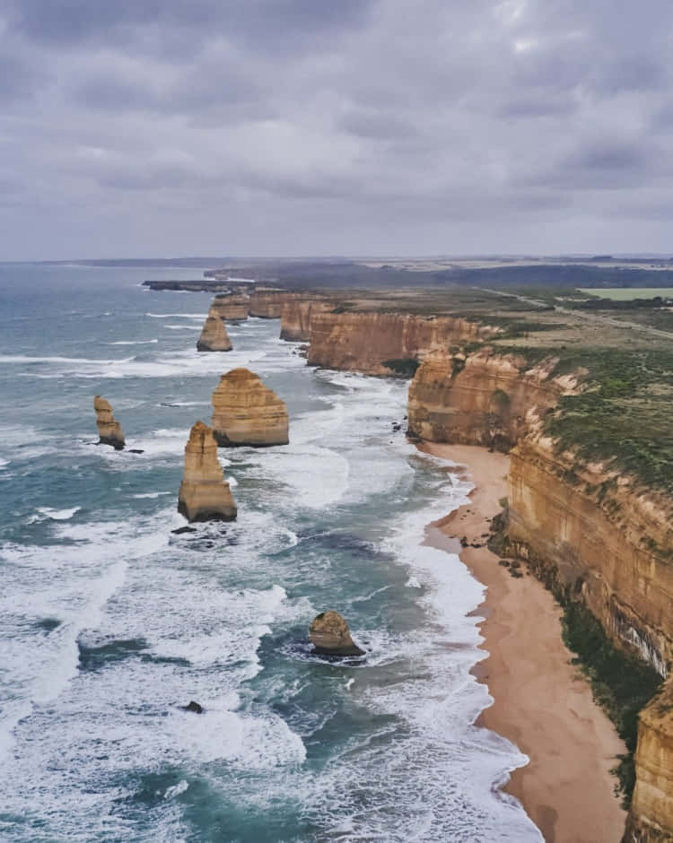 Twelve Apostles In Victoria Australia With Heavy Clouds Wallpaper