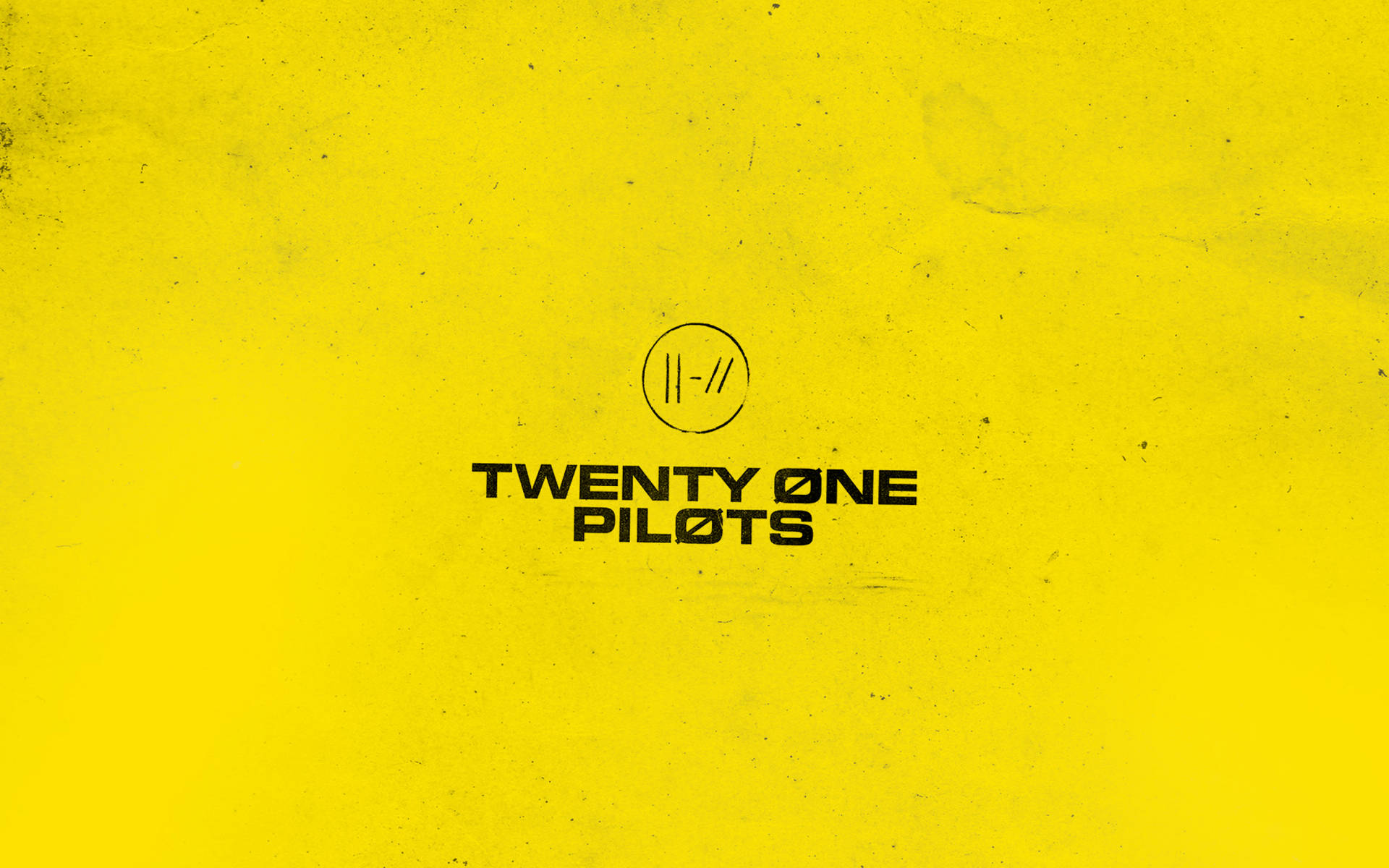 Twenty One Pilots logo in a vibrant yellow Wallpaper