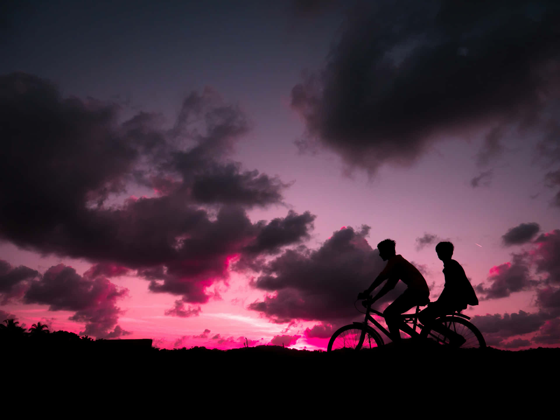 Twilight Bike Ride Silhouette Wallpaper
