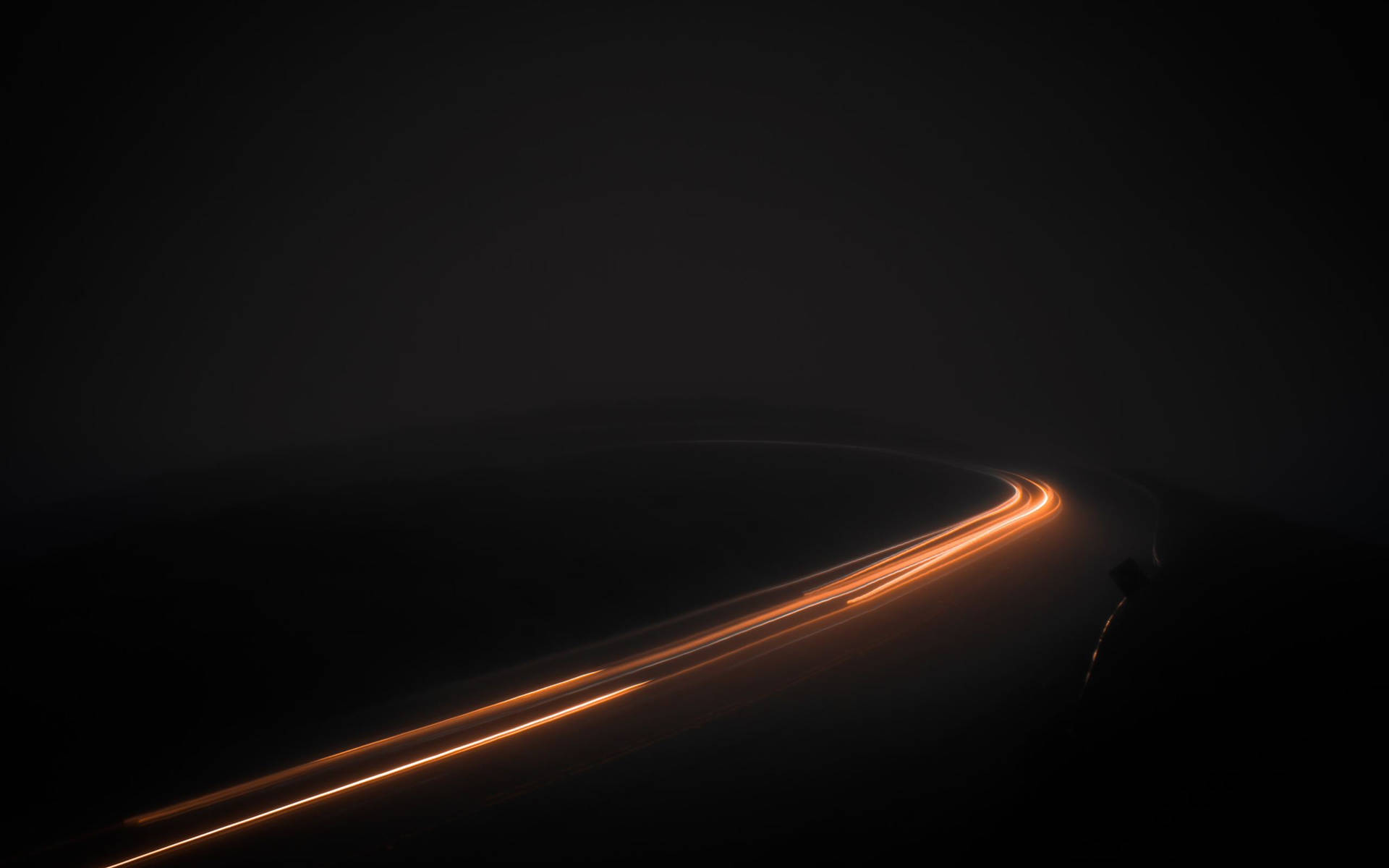 A Dark Road With Light Trails In The Dark Wallpaper