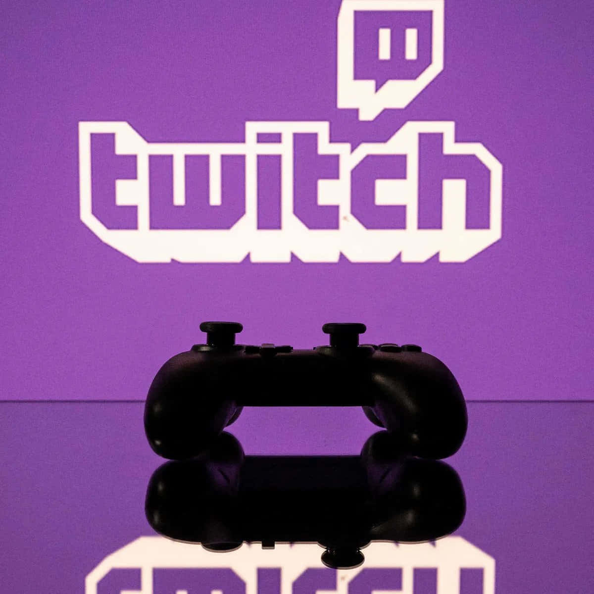 A Video Game Controller Is In Front Of A Purple Background