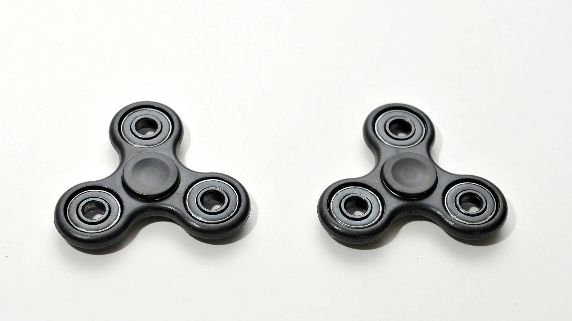 Two Black Fidget Toys Wallpaper