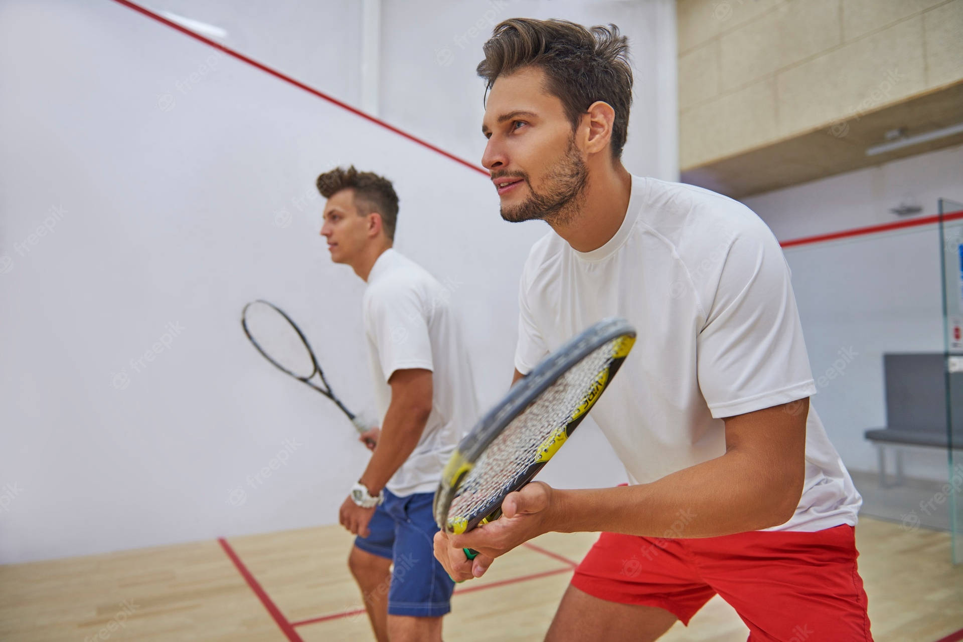 Two Boys In White Playing Squash Background