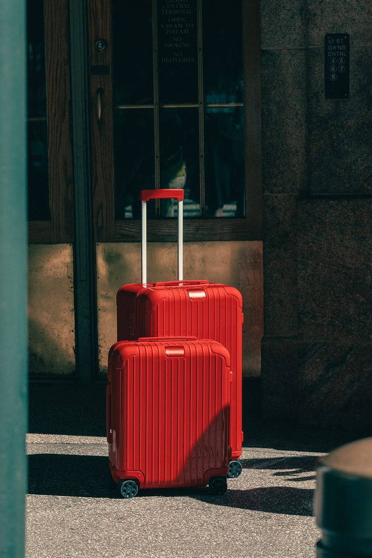 Two Flamingo Red Rimowa Suitcases Wallpaper