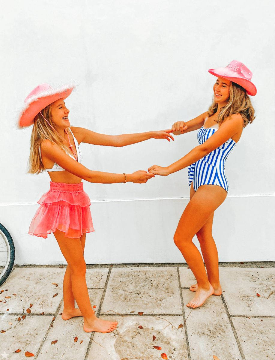 Two Girls Holding Hands Preppy PFP Highly Saturated Wallpaper