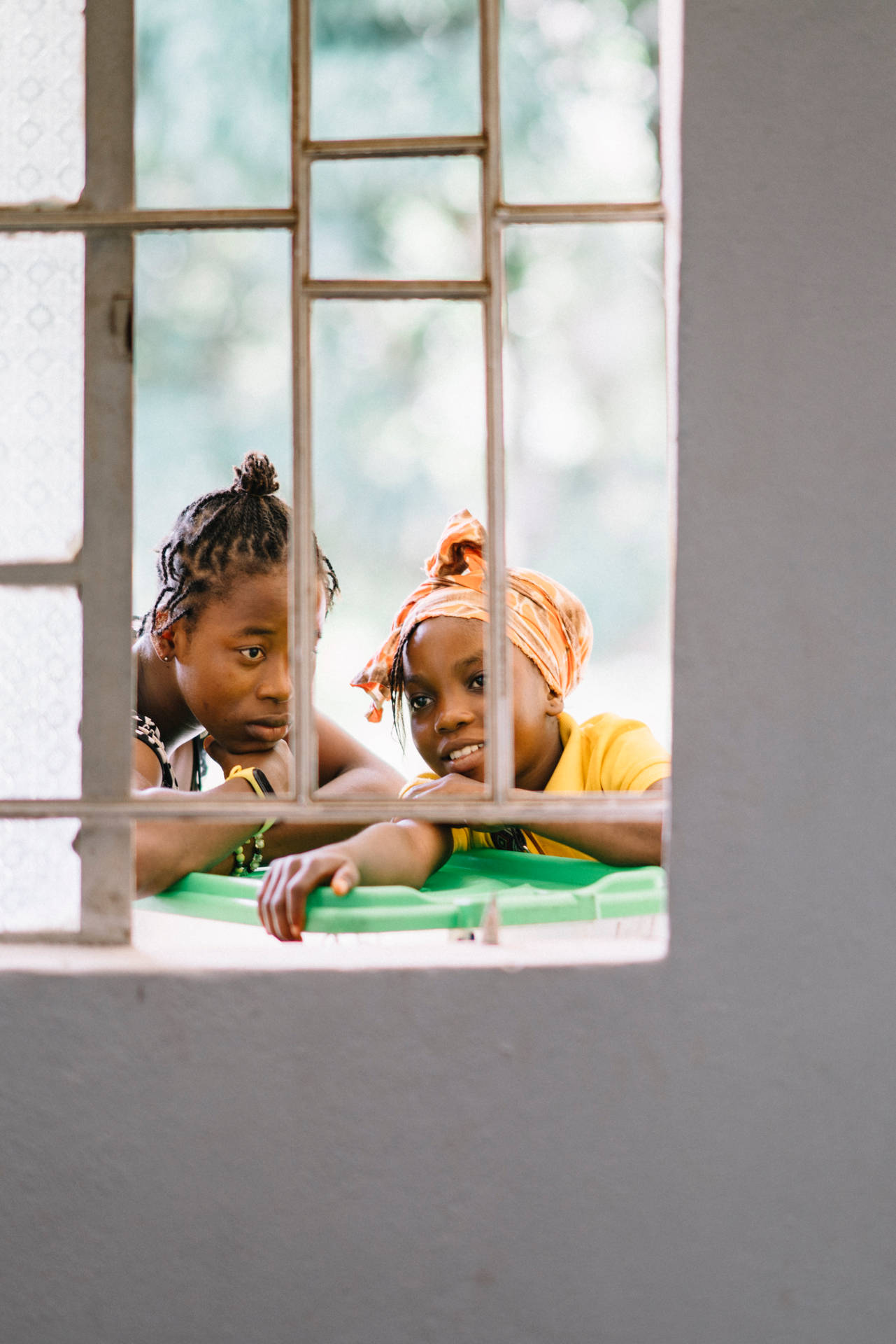 Two Girls Outside Window In Sierra Leone