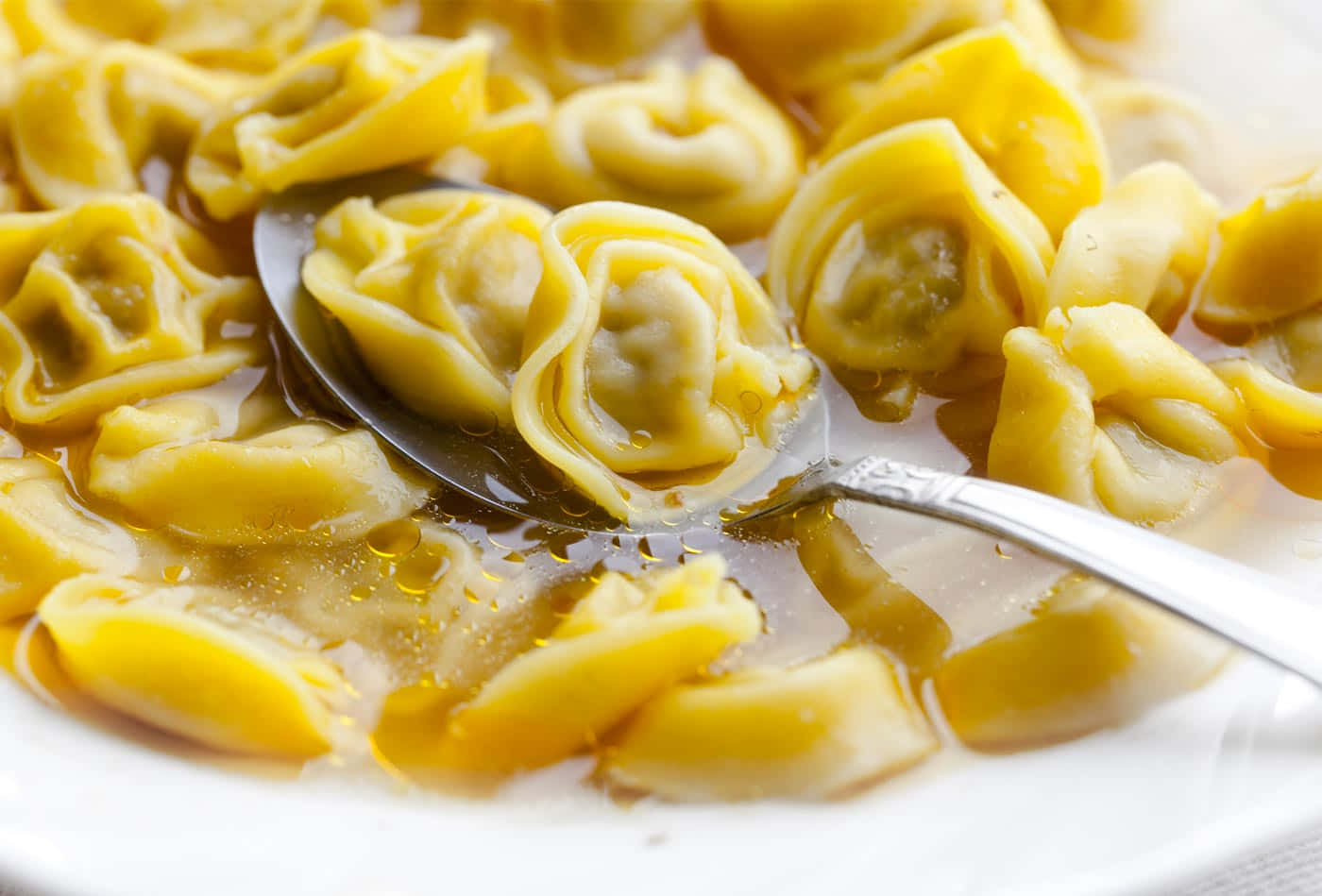 Download Two Tortellini In Brodo On A Spoon Wallpaper | Wallpapers.com