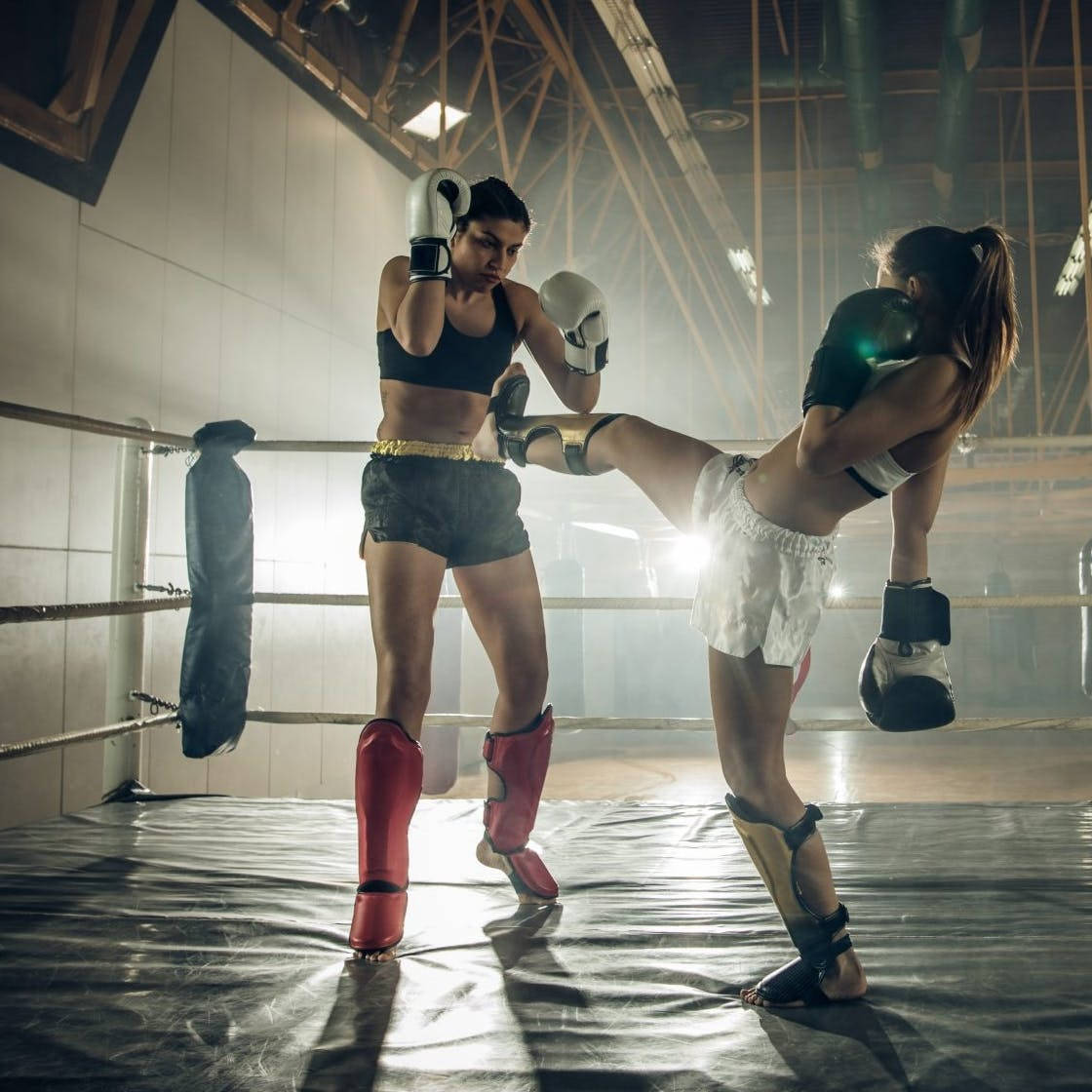 Intense Kickboxing Sparring Session Among Two Female Athletes. Wallpaper